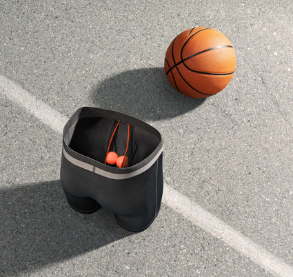 SAXX boxer briefs with two orange balls in the BallPack Pouch, on a basketball court