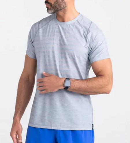 Man wearing a gray cooling mesh shirt and a smart watch