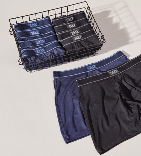 Black and blue boxer briefs folded in a basket